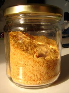 a glass jar filled with food sitting on top of a white counter next to a computer keyboard