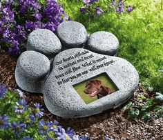 a memorial stone with an image of a dog's paw