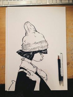 a drawing of a woman with a hat on top of her head, next to a keyboard