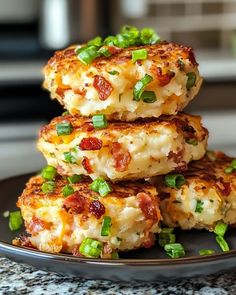 three crab cakes stacked on top of each other with green onions and scallions