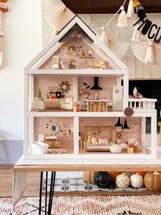 a doll house with furniture and decorations on display