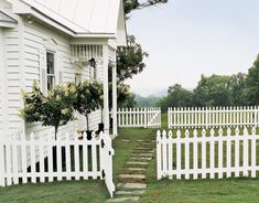 a white picket fence in front of a house