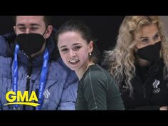 two people wearing face masks while sitting next to each other