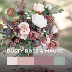 a vase filled with lots of flowers on top of a white table covered in greenery