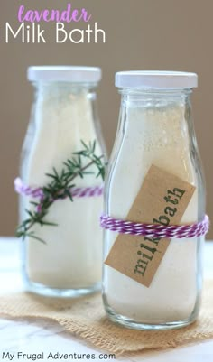 two jars with lavender and milk in them on a table next to a tag that says lavender milk bath