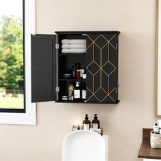 a bathroom with a sink, mirror and cabinet in it's center area next to a window