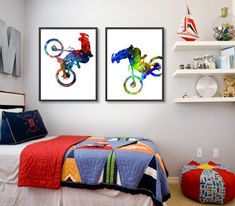 two framed art prints on the wall above a bed in a child's bedroom