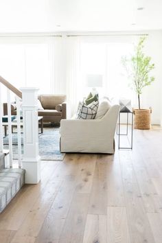 a living room filled with furniture and wooden floors