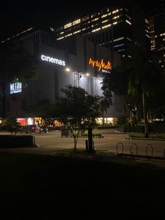 the building is lit up at night with neon lights