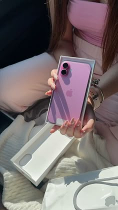 a woman holding an iphone in her hand with the phone case open and showing it's camera lens