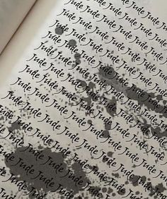 an open book with ink splattered on the pages and writing in black ink