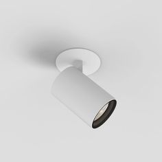 an image of a white ceiling light on a gray background with dim lighting in the corner