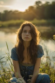 Young woman sitting in a sunlit field by a calm river during sunset, looking thoughtfully into the distance. Lake Photoshoot Aesthetic, Senior Photos At Lake, Lake Portrait Photography, Lake Photography Ideas, Chill Poses, Photography In Woods Women, Lake Photo Ideas, Lake Photoshoot Ideas, Dock Photoshoot