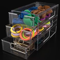 an acrylic box filled with lots of different colored items