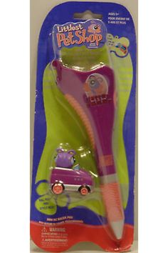 the purple toothbrush is in its package with an animal on it's head