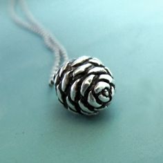 "This pine cone necklace is cast in solid sterling silver from a mold of a small fir cone, and it hangs from a 16\" 1 mm sterling silver ball chain. The pendant measure 14 mm or slightly over half an inch. An 18\" chain is also available at no additional cost; 16\" length is pictured. Oxidation emphasizes the detail, but this necklace also looks great with a bright finish, as shown in the last photo, either with a rolo or ball chain. Pendant without a chain is also available.  The larger version Pine Cone Necklace, Pinecone Necklace, Gardening Gift, Botanical Jewelry, Tree Tattoo, Basset Hound, Pine Cone, Garden Gifts, Ball Chain