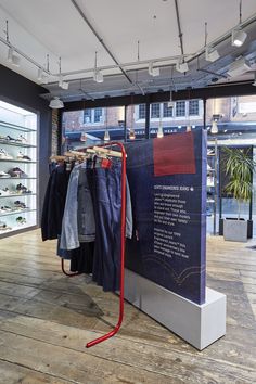 a display in a clothing store with clothes hanging on racks