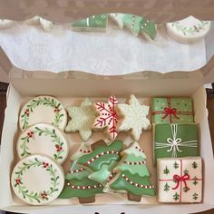 an open box filled with christmas cookies and decorated cookies