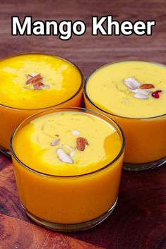 three glasses filled with mango kheer on top of a wooden table