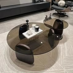 a glass table with two chairs and a coffee table in the middle on a carpeted floor