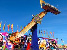 the carnival rides are decorated with colorful flags