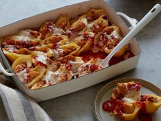 a casserole dish with meat and cheese in it on a plate next to a fork