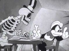 the skeleton is eating at the table in front of mickey mouse and goofy from lorax