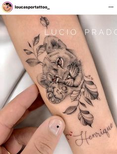 a woman's arm with a cat tattoo on it