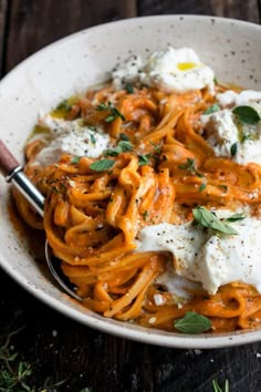 a white bowl filled with pasta and cheese