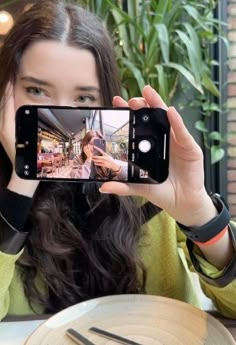 a woman taking a selfie with her cell phone