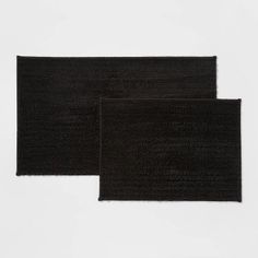 two black rugs sitting next to each other