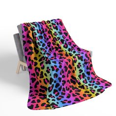 a colorful leopard print blanket sitting on top of a chair