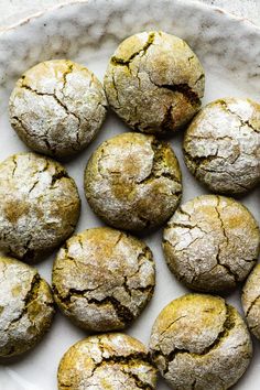 a white plate topped with cookies covered in powdered sugar