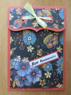 a handmade card with flowers and ribbon on the front, says bon annversie