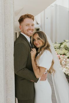 a bride and groom posing for the camera