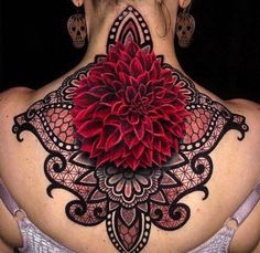 the back of a woman's neck with a large flower on top of it