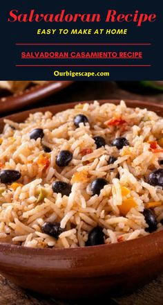 a bowl filled with rice and beans on top of a wooden table