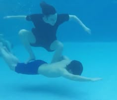 two people are diving in the water