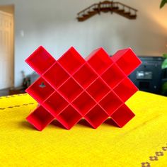 a red object sitting on top of a yellow table