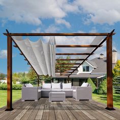 an outdoor living area with couches, table and pergolated roof over it