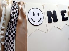 there is a banner with a smiley face hanging from it's side and ribbon around the corner