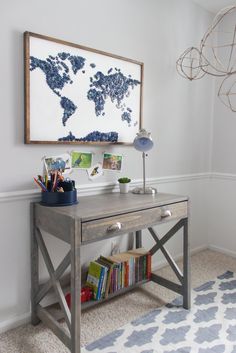 a desk with a map on the wall above it