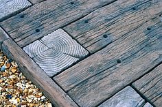 a wooden walkway with rocks and gravel around it