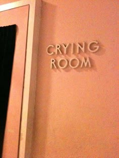 there is a sign that says crying room on the wall