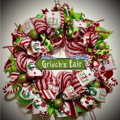 a christmas wreath with the words grin's fair on it and candy canes