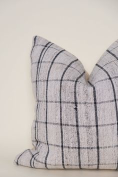 a black and white plaid pillow sitting on top of a table