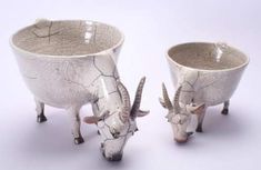 two white ceramic bowls with horns on them