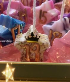 a close up of a birthday cake with candles in the shape of numbers and stars