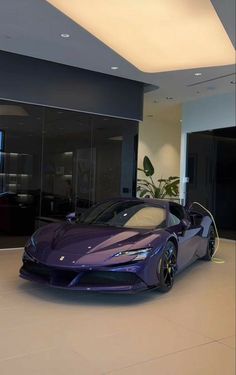 a purple sports car is parked in a large room