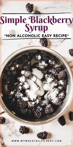 a bowl filled with blackberries covered in powdered sugar on top of a marble counter